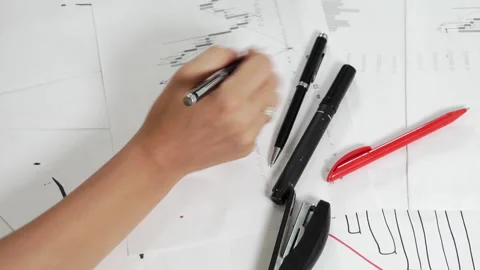 Work table with stock tables and stationery. Stock Footage 158606802