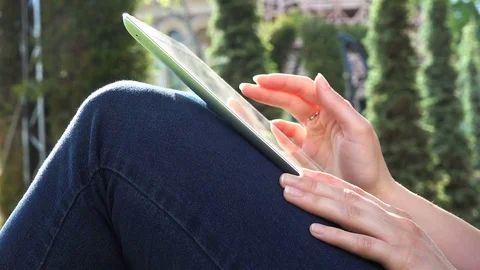 Work in a tablet on a woman's knee Stock Footage 79697262