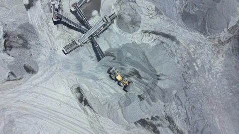 Work takes place at a granite quarry site with machinery moving and processing Stock Footage 339481743