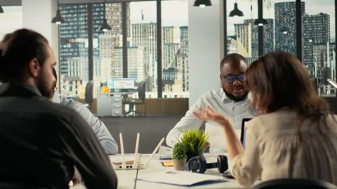 Work team engaged in negotiation and project consulting during business meeting Stock Footage 320740878