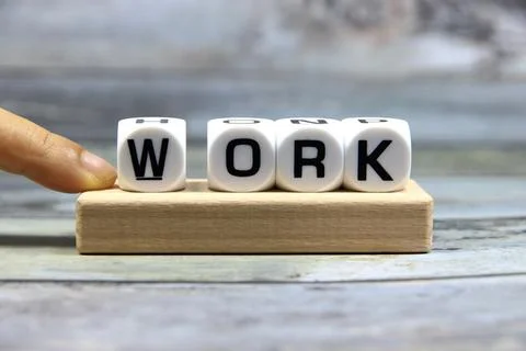 "WORK" text or message short word letter on white plastic block with hand a.. Stock Photos