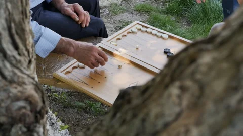 Work textured and rough male hands senor men play backgammon with a young man Video stock 194810328