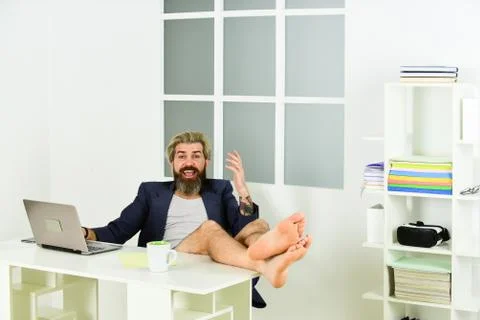 Work through evening or procrastinate further. Man doing business from home Stock Photos