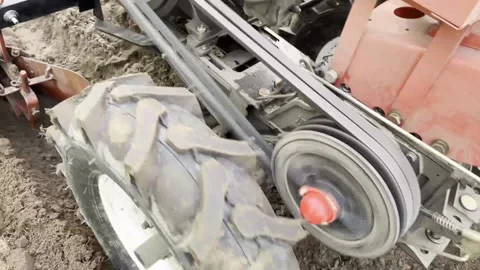 The work of a tillerblock that plows the ground in the field Stock Footage 256476469