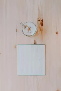 Work time concept. Coffee and a notebook on a natural pine table. Quiet works Stock Photos