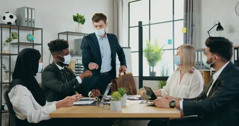 Work in time of covid-19 where good-looking confident main manager approaching Stock Footage 159597937