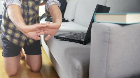 Work tired man using his laptop doing relaxation exercises. HD footage. Stock Footage 147250517