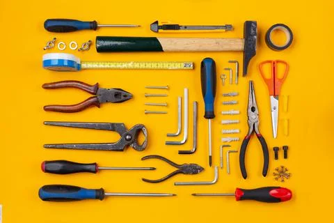 Work tools arranged on an orange background Stock Photos