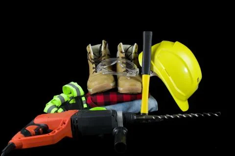 Work tools for construction worker  on black background. Stock Photos