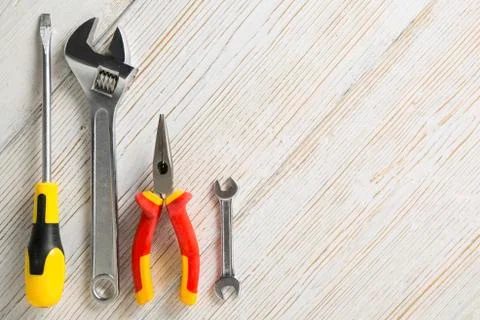 Work tools, instruments on white wooden background, technical support Stock Photos
