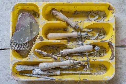 Work tools for pottery in a yellow box. top view Stock Photos