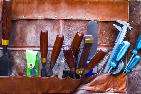 Work tools A selection of carpentry tools hang in a workshop for woodwork Stock Photos