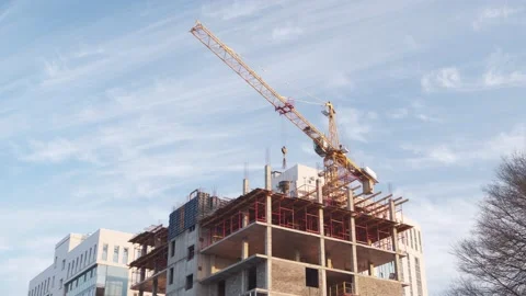 The work of a tower crane in the construction of an apartment building. Vidéo 143117752