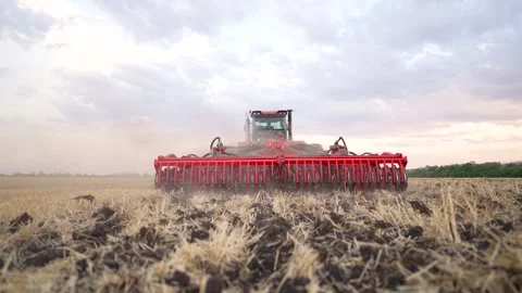 Work of tractor on field. Agricultural work on ground. tractor works on an Stock Footage 252108849