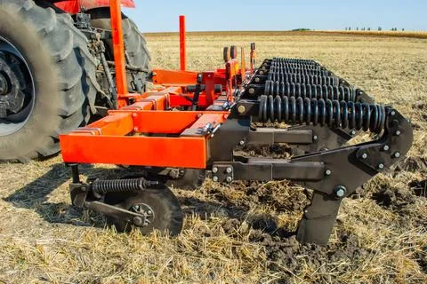 Work of the trailed unit for tillage in the field Stock Photos