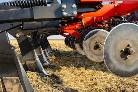 Work of the trailed unit for tillage in the field Stock Photos