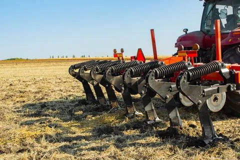 Work of the trailed unit for tillage in the field Stock Photos