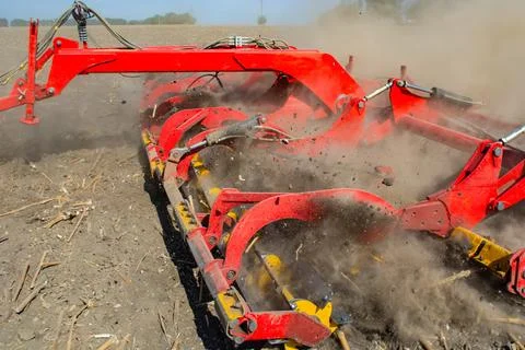 Work of the trailed unit for tillage in the field Stock Photos