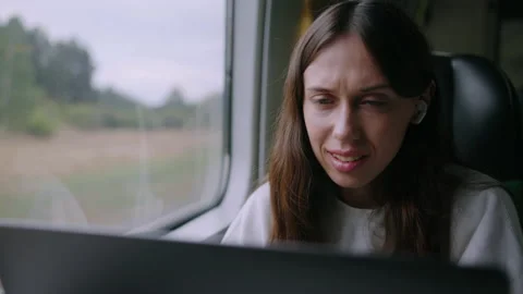 Work on the train. A young woman during a video call with colleagues Stock Footage 218017586