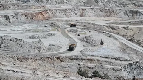 Work of trucks and the excavator in an open pit on gold mining, soft focus Stock Footage 168907929