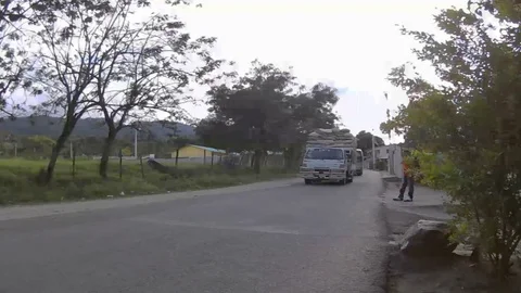 Work trucks on a Dominican Road Stock Footage 127471706