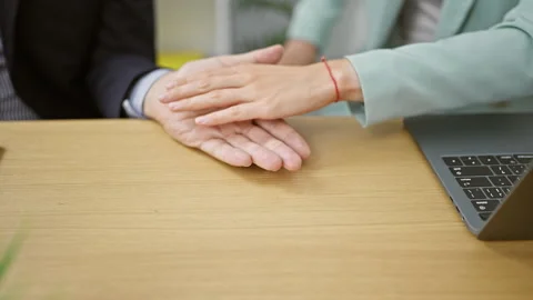 At work, two business workers sitting together at office table, hands joine.. Stock Footage 262770484
