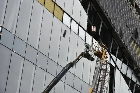 Work is underway to install a ventilated facade. Stock Photos