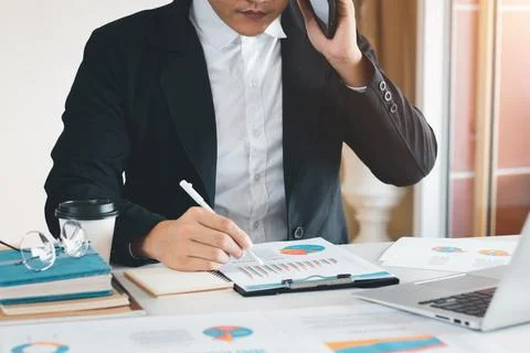 Work using mobile phone typing computer mobile chat laptop contact us at work Stock Photos