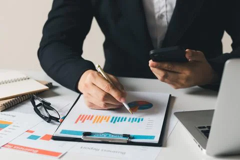 Work using mobile phone typing computer mobile chat laptop contact us at work Stock Photos