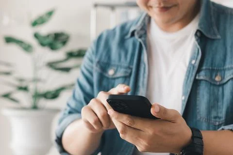 Work using mobile phone typing computer mobile chat laptop contact us at work Stock Photos