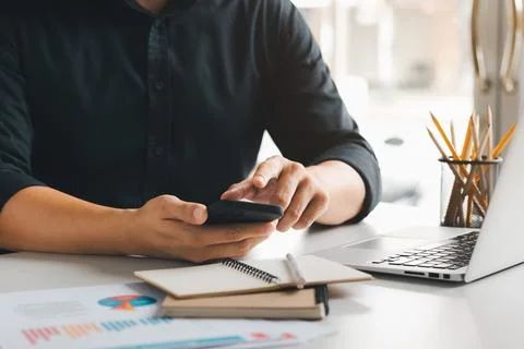 Work using mobile phone typing computer mobile chat laptop contact us at wo.. Stock Photos