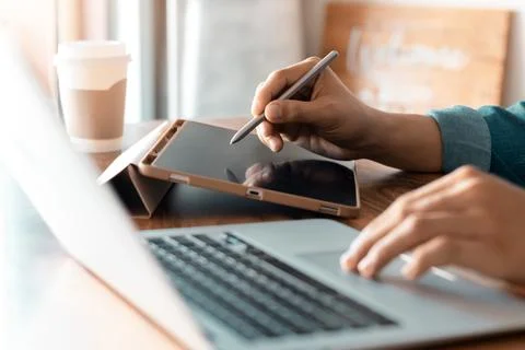 Work using tablet typing computer mobile chat laptop contact us at workplaces Stock Photos