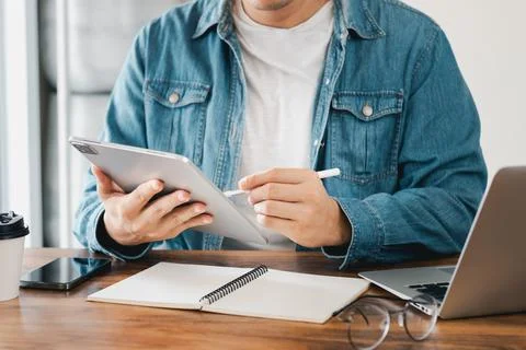 Work using tablet typing computer mobile chat laptop contact us at workplaces Stock Photos