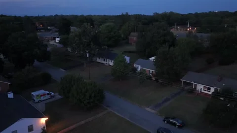 Work van and lit porch on a Lynchburg street at nightfall Stock Footage 346619486