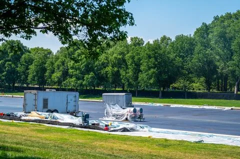 Work vehicles, equipment parked on drained blue Reflecting Pool Washington DC Stock Photos