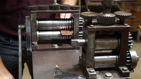 Work on a vintage mechanical tool for cutting and compressing copper plates for  Stock Footage 82624379