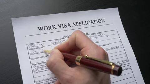 Work Visa Application Form Closeup Of Hand Hand Filling the Document Stock Footage 76444913