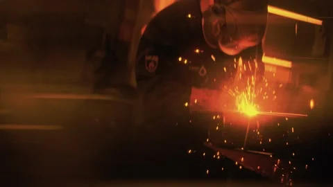 Work of a welder is reflected in golden light in the visor of the welding mask. Stock Footage 212402970