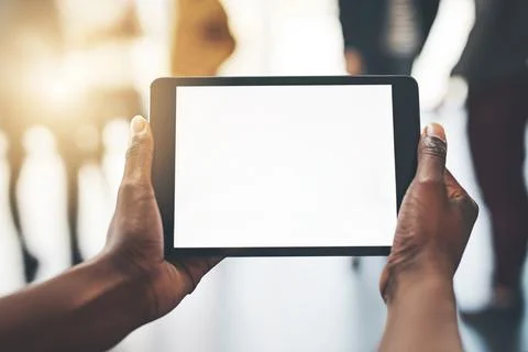 Work wirelessly with this device. Shot of an unrecognizable man using a tablet Stock Photos
