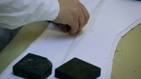 The work of a woman in a sewing workshop. Creating a pattern initial stage Stock Footage 95396173