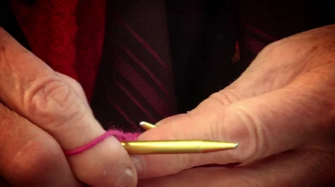 Work wool with knitting needles: Grandma is making a scarf or sweater Stock Footage 64277331