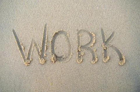 Work word on beach sand. Work phrase is written on a sand. Top view Stock Photos