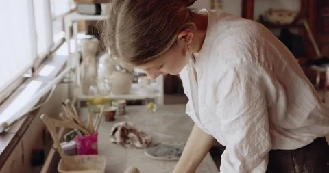 Work with your hands: closeup of creative woman molding raw clay before Stock Footage 207070156