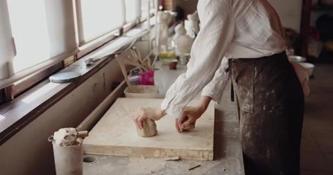 Work with your hands: closeup of creative woman molding raw clay before Stock Footage 208075380