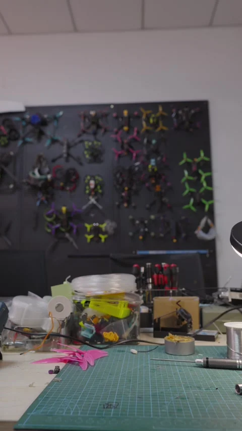 Workbench full of tools and parts for building, repairing custom fpv racing Stock Footage 328986710