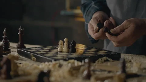 Workbench, Middle-aged builder Confidently looking at a chess piece In a car Stock Footage 243008740