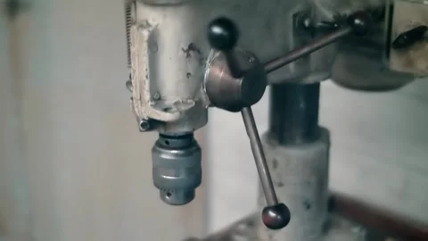 On workbench is obsolete electric drilling machine tool with different pulleys Stock Footage 323965385