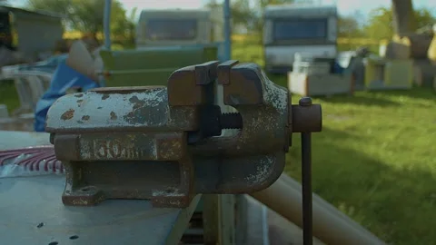 Workbench with vice outside, old trailers in background. Stock Footage 138090672