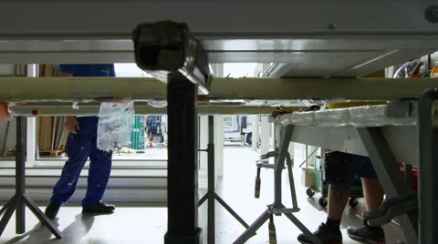 Worker adding the final touches to a window frame in the factory Stock Footage 63022022
