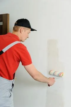 Worker adhesive wallpapers. Stock Photos